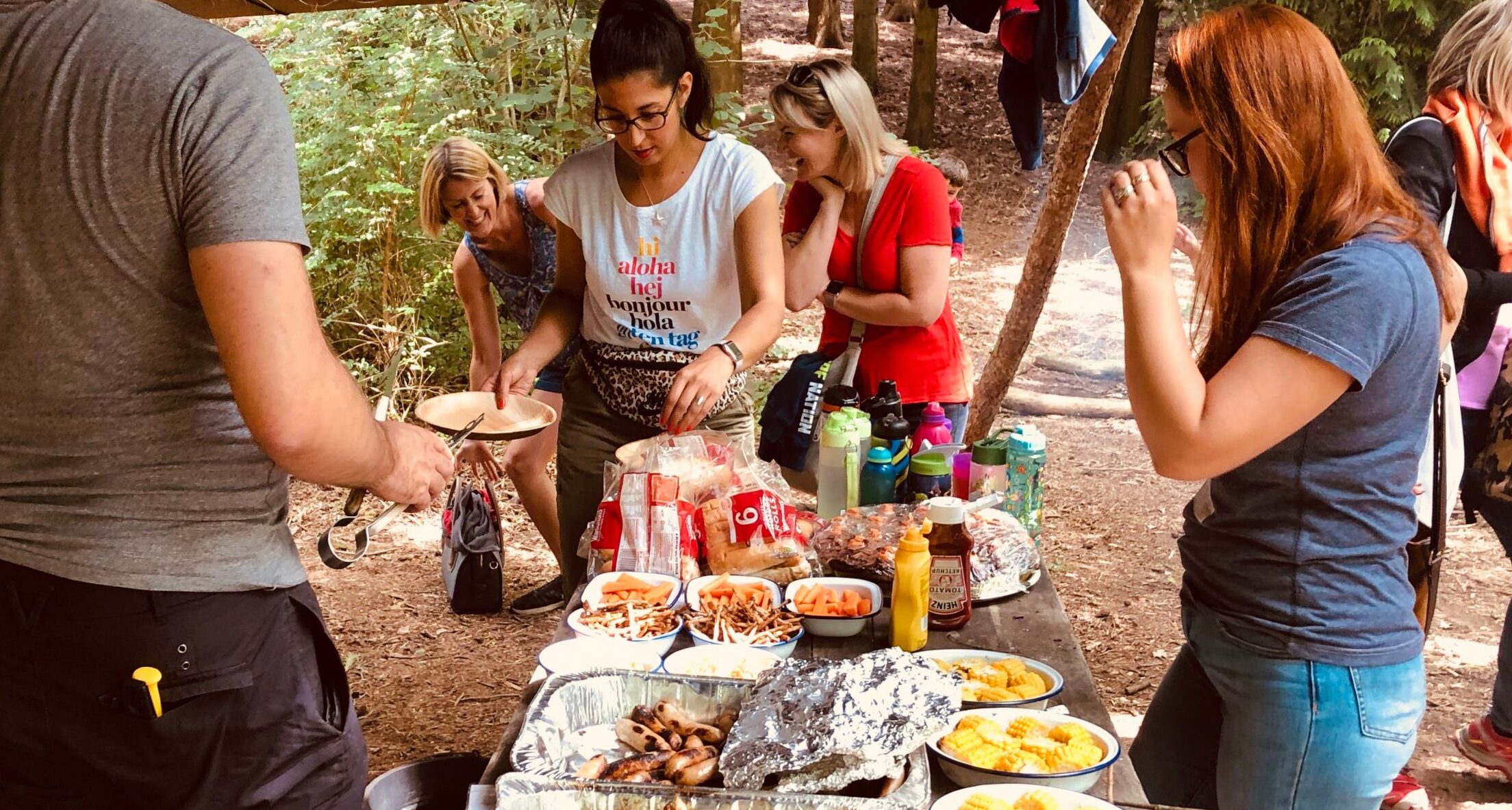 adultseatingnexttotableundercoverinwoods_15-7